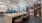 a large social room with a bar and chairs and ample seating options