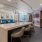 a large social room with a bar and chairs and ample seating options