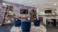 a room with a tv, table and chairs