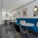 a room with a long booth seat and tables and chairs