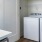 In-unit laundry with ample shelving at Legacy Encore