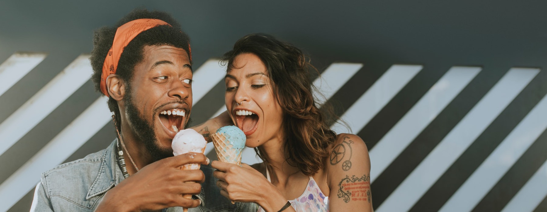 A guy and girl eat ice cream